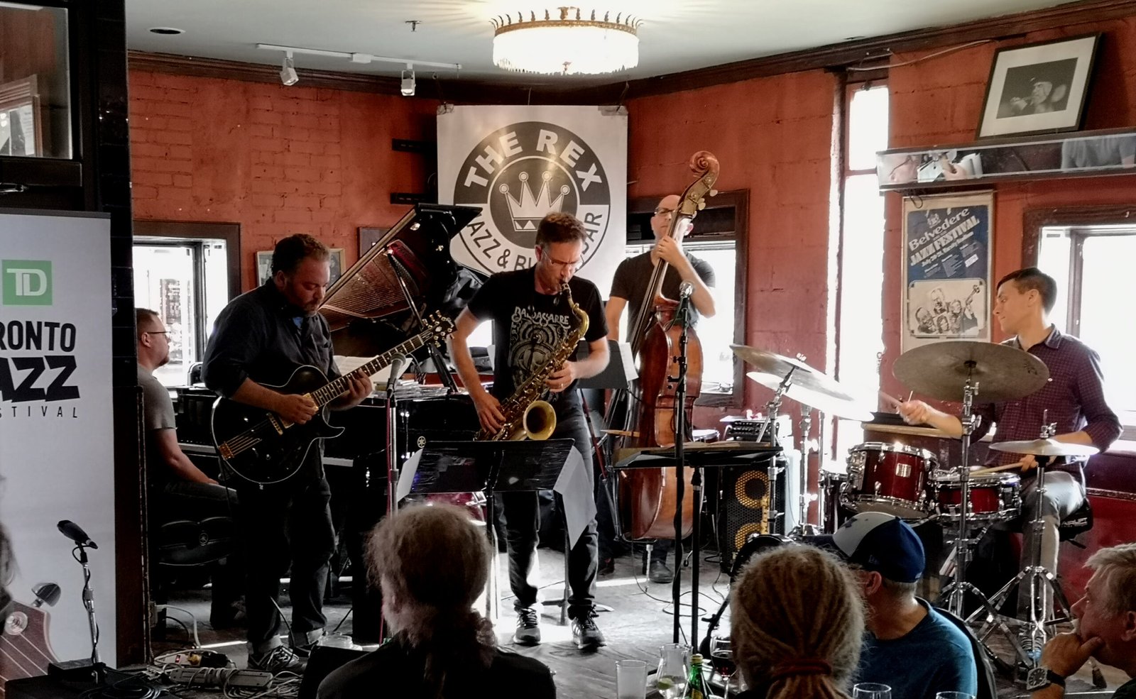 A saxophone player leads a five piece band at The Rex as part of the TD Jazz Festival in Toronto in 2018